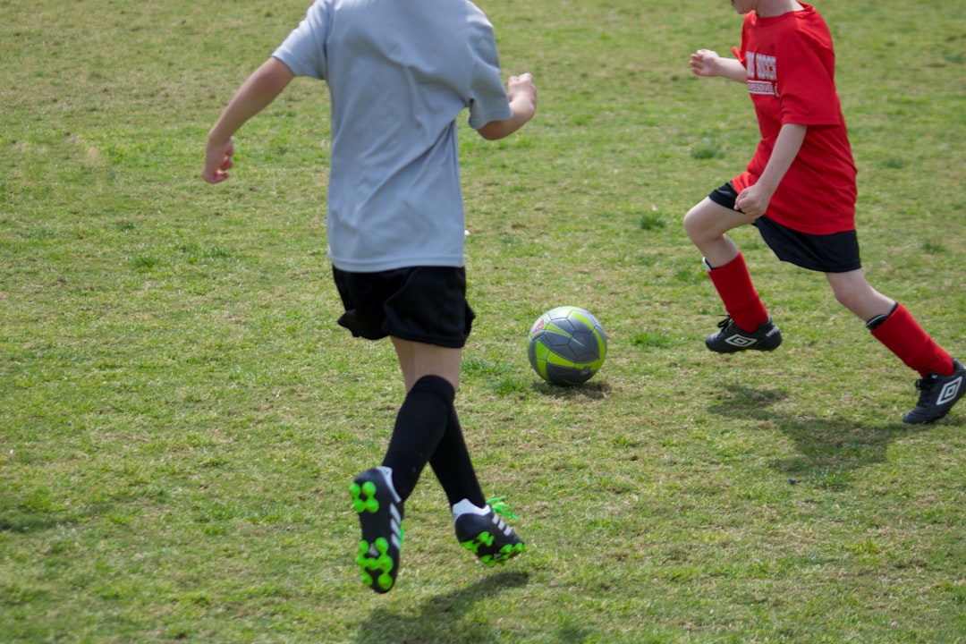 about-img woman-in-white-shirt-and-black-shorts-playing-soccer-0axqbri8or4